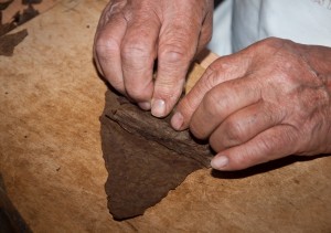 Hands wrapping a cigar